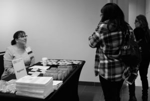 Laura Renfro welcomes attendees at the registration table